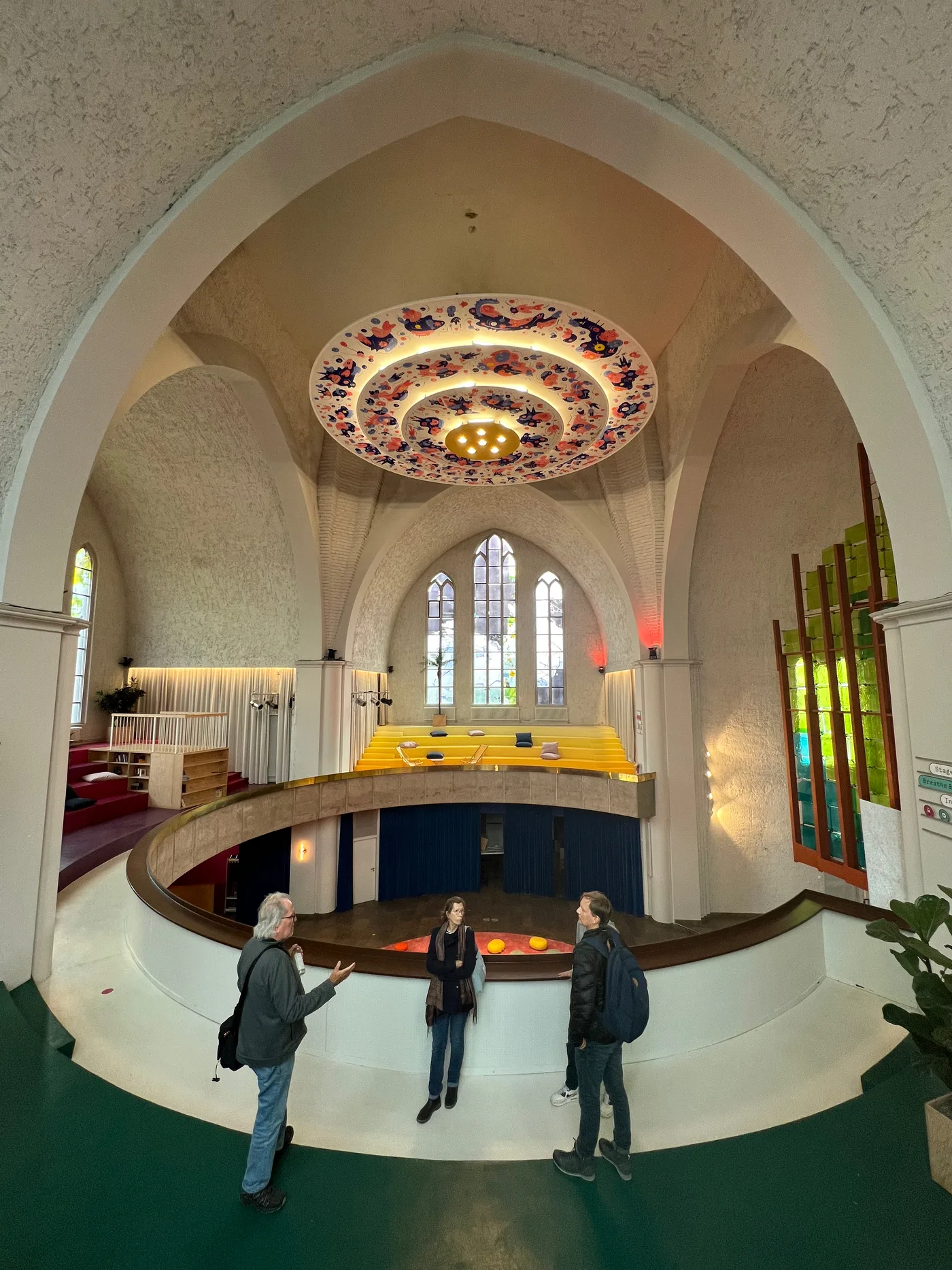 Visitors beneath the illuminated sculpture